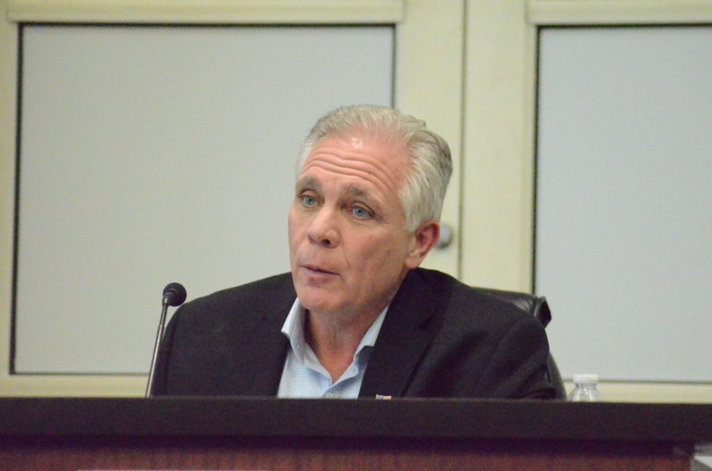Orland Park Mayor Keith Pekau reads part of a scathing email that wished bad things on him and his family on Tuesday night. (Photo by Jeff Vorva)