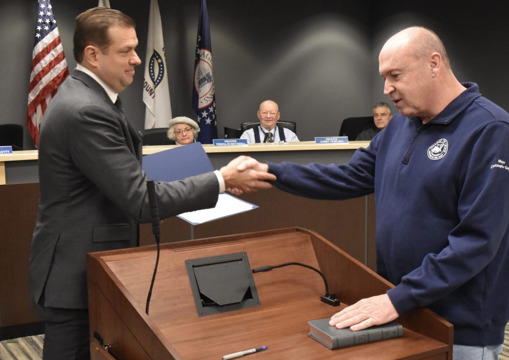 Lyons Mayor Christopher Getty congratulates Steven Karasek after he was sworn in Jan. 4 as a commissioner on the village’s Zoning Board of Appeals. (Photo by Steve Metsch) 