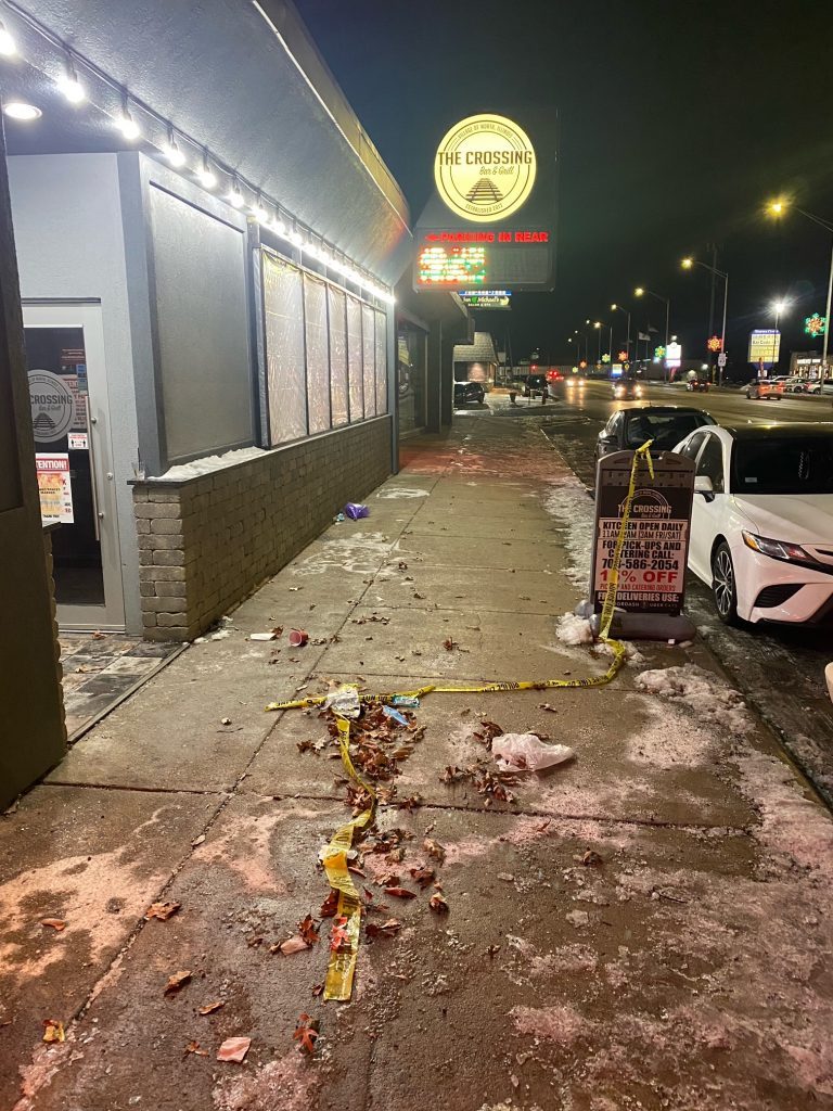 Crime scene tape lies on the sidewalk in front of the Crossing Bar and Grill in Worth where two men were shot and killed early Monday morning. (Photos by Linda Bogard) 