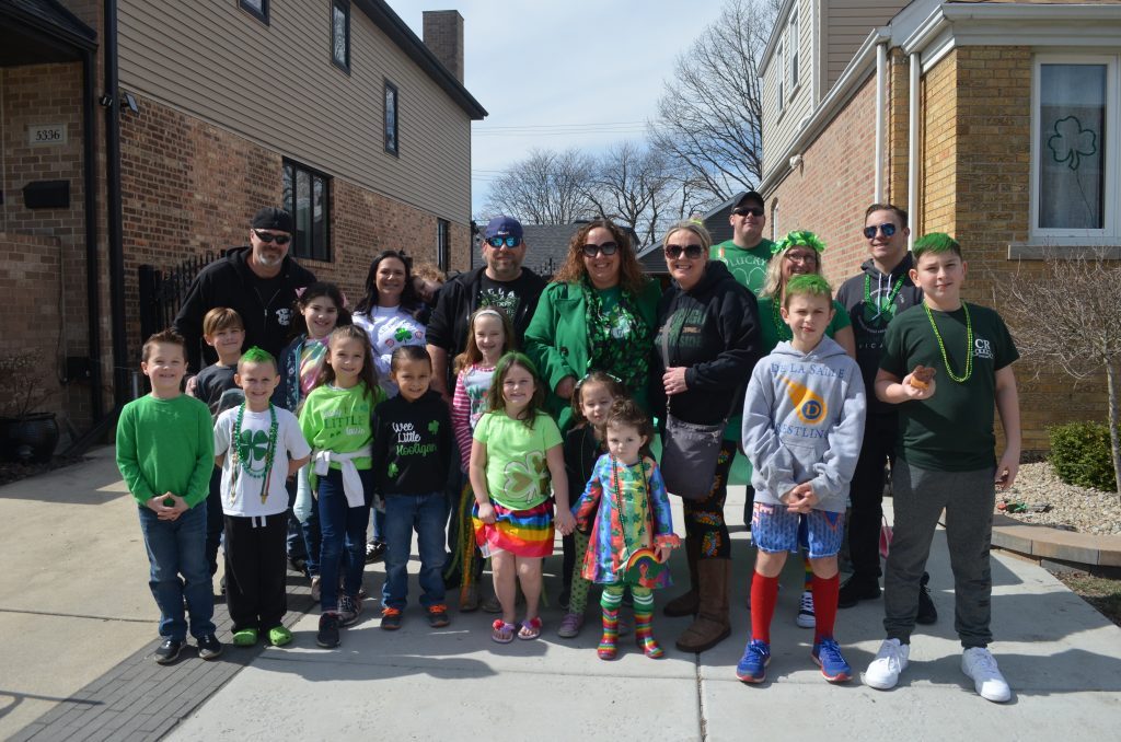 The neighborhood St. Patrick’s Day parade is a family-focused event, and those at the curb are often as colorful and interesting as those in the parade itself—as these parade goers proved in 2021. --Photo by Cosmo Hadac