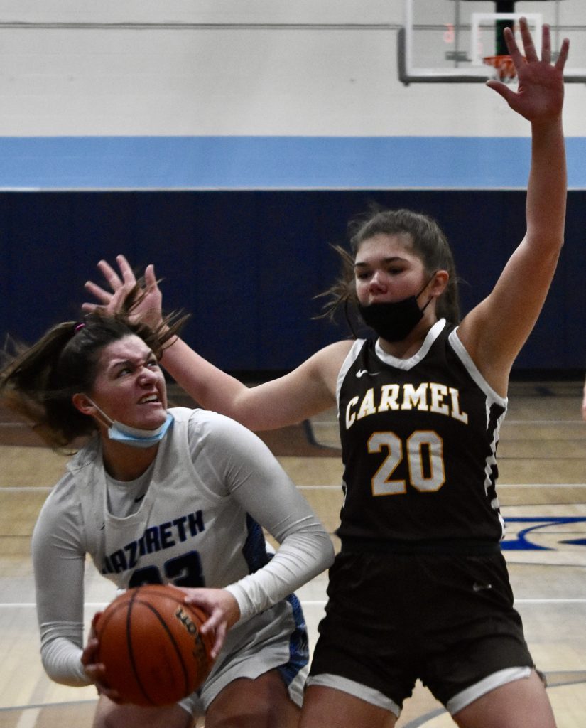 Nazareth’s Danielle Scully prepares to take a shot while guarded by Carmel’s Mia Gillis in the East Suburban Catholic championship game. Photo by Steve Metsch