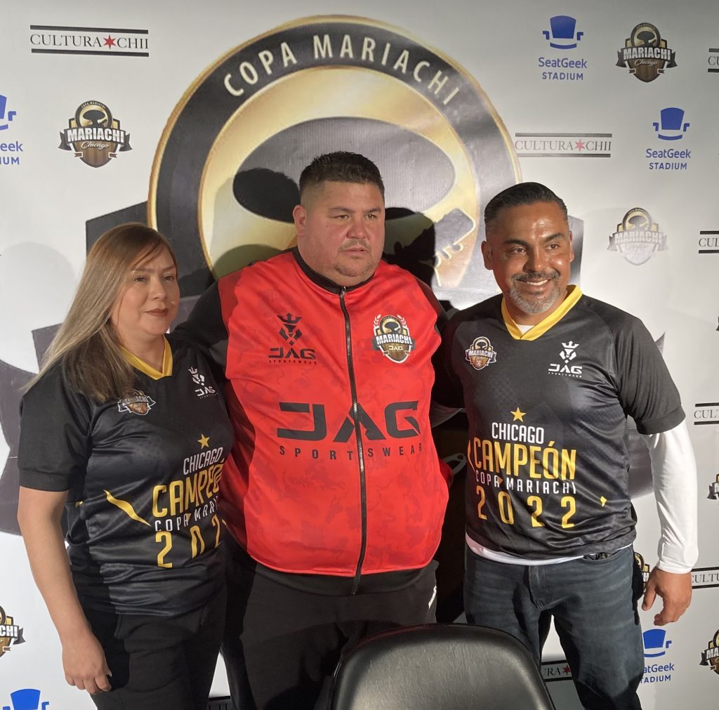 Mitzi Blanco and Julio Roa (center), of Copa Mariachi, with Emilio Herrera of JAG Sportswear are bringing an international soccer tournament to Bridgeview this summer. (Photo by Steve Metsch) 