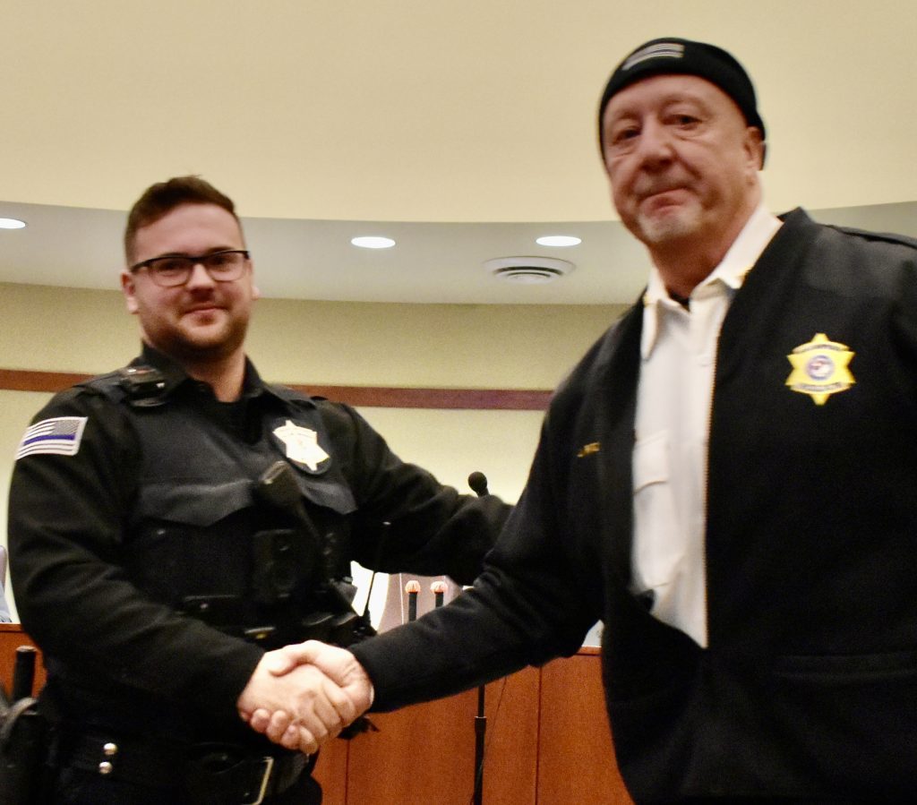 Willow Springs Police Chief Jim Ritz (right) congratulates new part-time police officer Anthony Vosicky. (Photo by Steve Metsch)