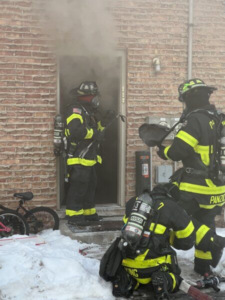 Orland firefighters enter an apartment building on Sunday morning. (Photo courtesy of Orland Fire Protection District)