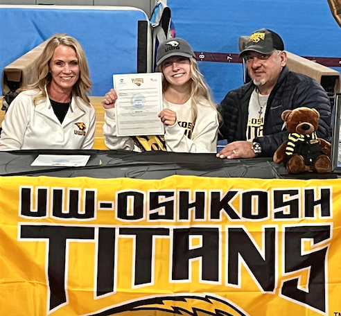 Top-level gymnast Aleah Radovich (center) smiles with her mother, Danielle, and father, Dan, moments after she signed her letter of intent to continue her academic and athletic career at the University of Wisconsin-Oshkosh, where she will wear the black and gold and compete for the Titans. --Supplied photo