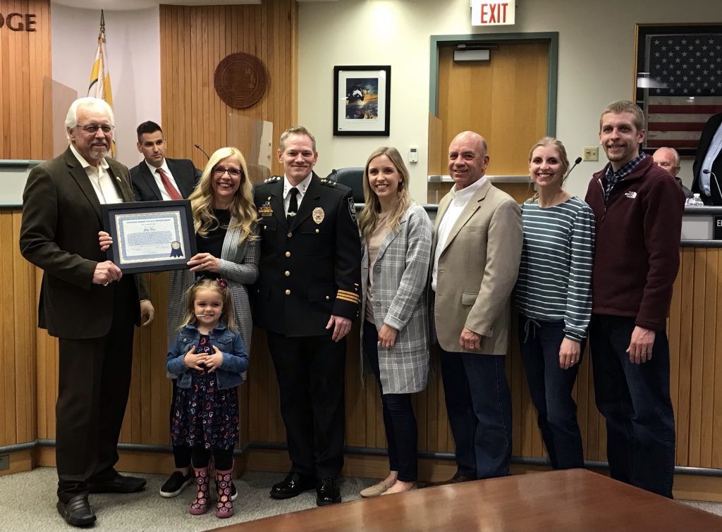 Chicago Ridge village secretary Judy King is joined by her family, Mayor Chuck Tokar (at left) and Police Chief Jim Jarolimek who presented her with the department’s Life Saving Award at the April 12 Village Board meeting. (Supplied photos)
