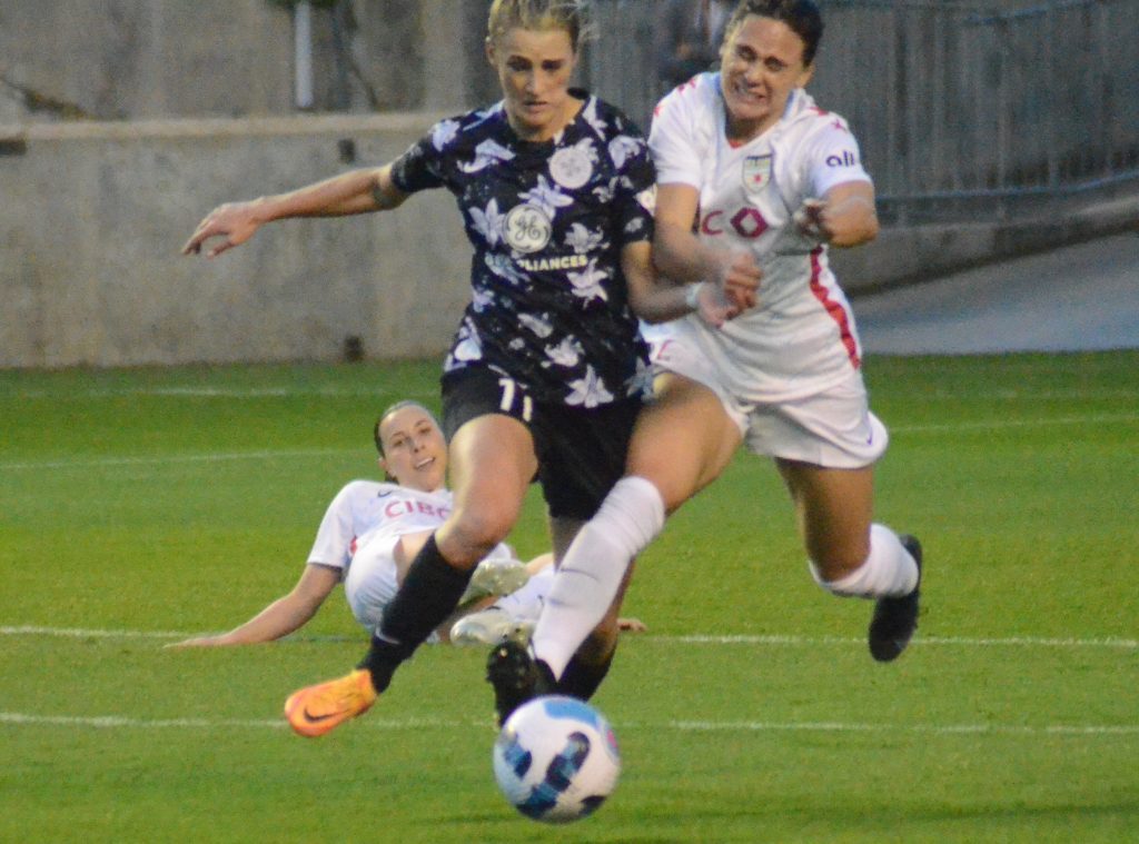 Louisville's Emily Fox (left) and the Red Stars' Bianca St-Georges jostle in the first half of April 30's game. Both scored goals in the Red Stars' 2-1 season-opening victory. (Photo by Jeff Vorva)