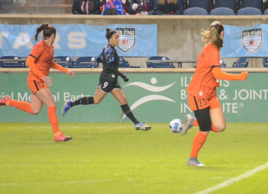 Mallory Pugh, middle, moves the ball during the preseason. She played her first NWSL game Sunday and had two goals and an assist. Photo by Jeff Vorva