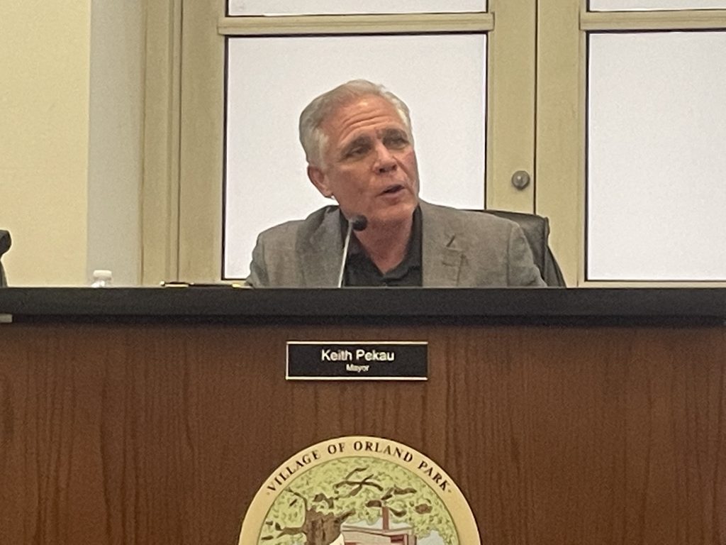 Orland Park Mayor Keith Pekau discusses the next steps in the Downtown Triangle project at the May 2 board meeting. (Photo by Jeff Vorva)