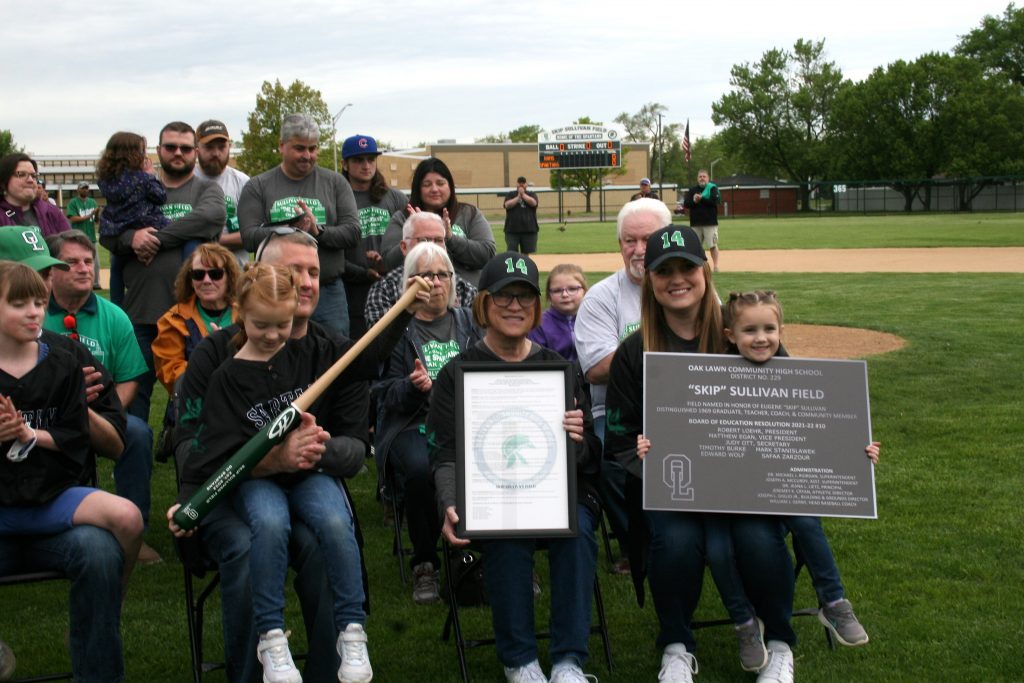 Patti Sullivan, widow of Skip Sullivan, holds a proclamation honoring her husband while her daughter, Dana Annel, holds a plaque commemorating the renaming of the Oak Lawn Community High School varsity baseball park, Skip Sullivan Field. They were joined by family and grandchildren for the dedication ceremonies on Tuesday. (Photos by Joe Boyle)