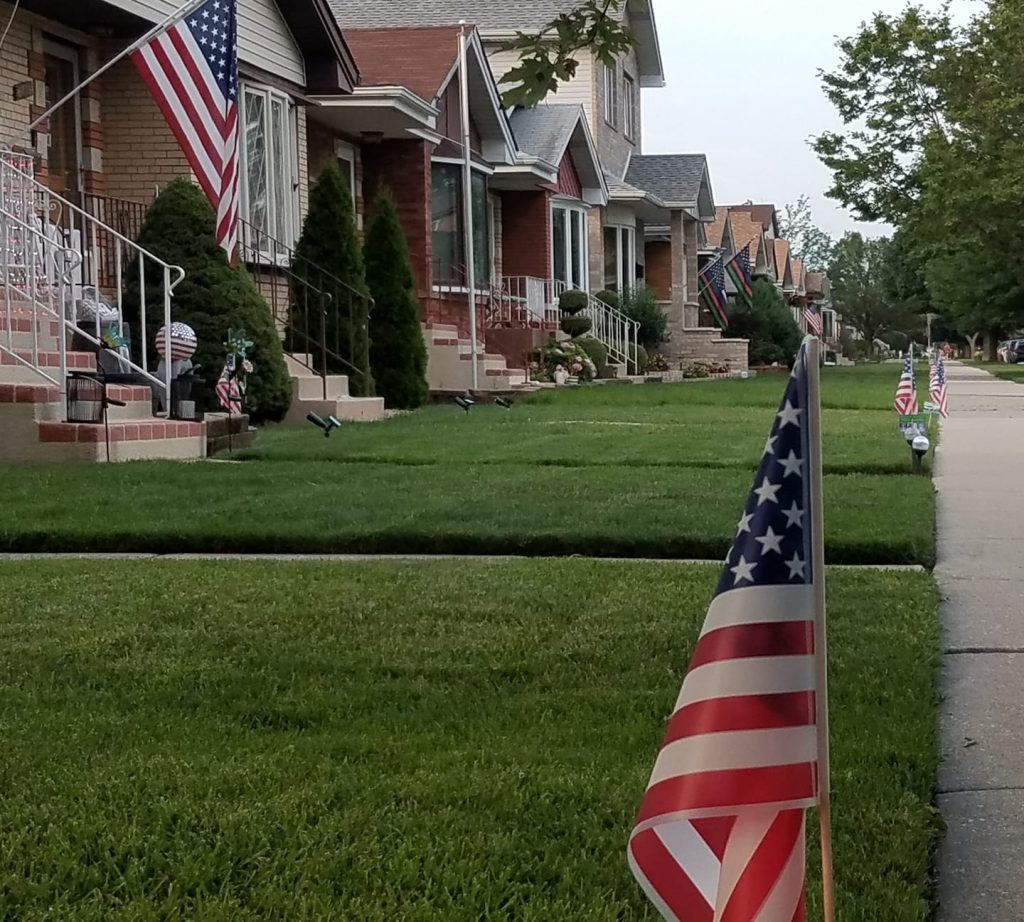 Thanks to Niego Real Estate, block after block in Clearing and Garfield are decked out each year in red, white and blue. Residents are asked to volunteer to pick up flags and decorate their whole block. --File photo
