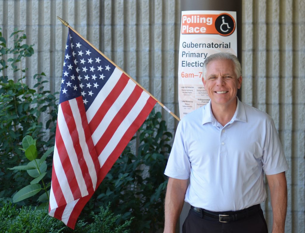 Orland Park Mayor Keith Pekau poses at Liberty School Tuesday during the primary election. (Photo by Jeff Vorva)