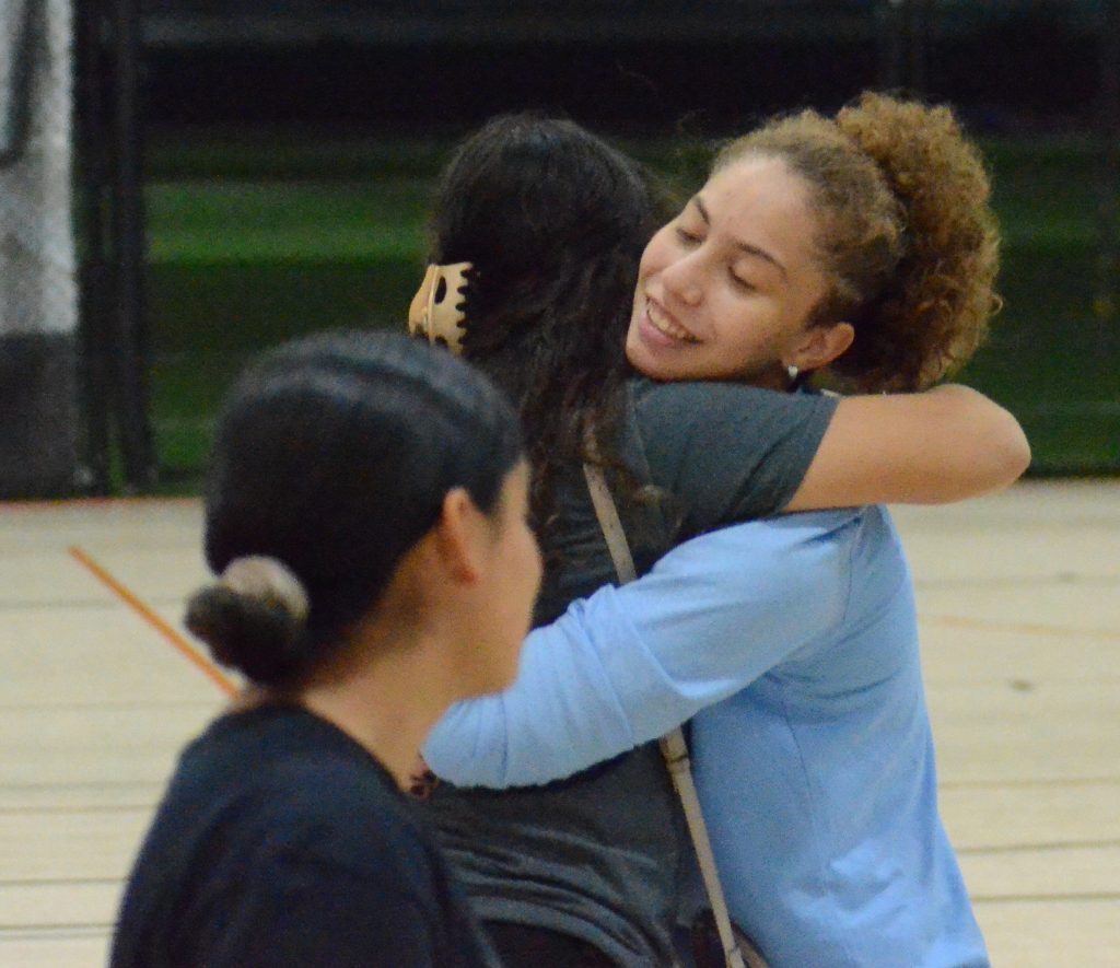 Back of the Yards graduate Roxy Herrera receives a hug after winning an award for being one of the top goalies in the country on Thursday. Photo by Jeff Vorva