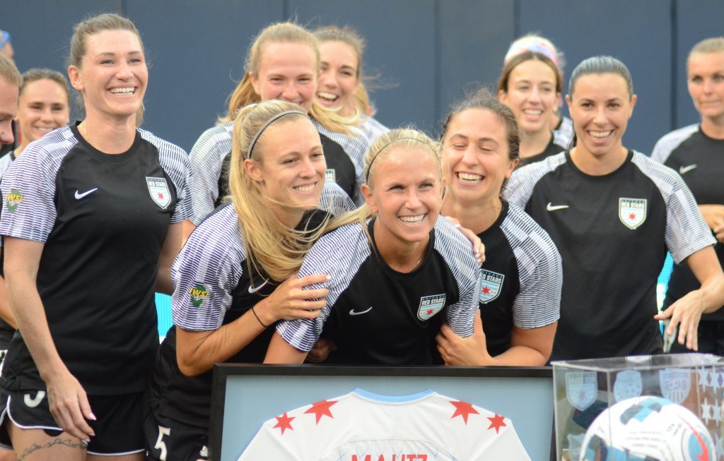 Alyssa Mautz (center) is joined by her teammate for a ceremony Saturday at Soldier Field before the Red Stars' loss to San Diego. Mautz retired and will be an assistant women's soccer coach at Texas A&amp;M. Photo by Jeff Vorva