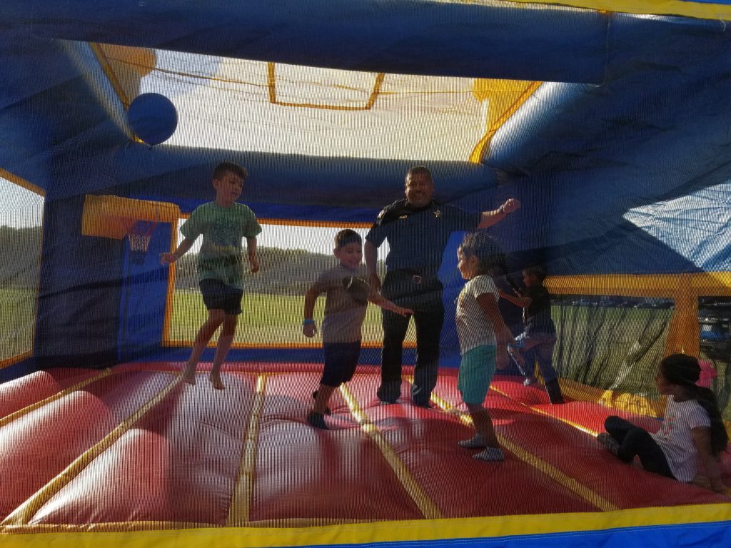 Acting Police Chief Mel Ortiz joins some kids in the bounce house at Summit's National Night Out last week. (Photos by Carol McGowan)