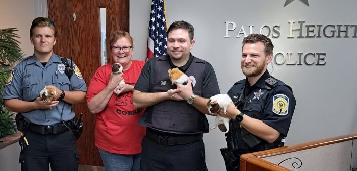 Palos Heights Community Service Officer Matthew Murray (from left), a volunteer from Critter Corral Guinea Pig Rescue, Cadet Matthew Kroll and Officer Dave Delaney hold the rescued guinea pigs. (Supplied photo)