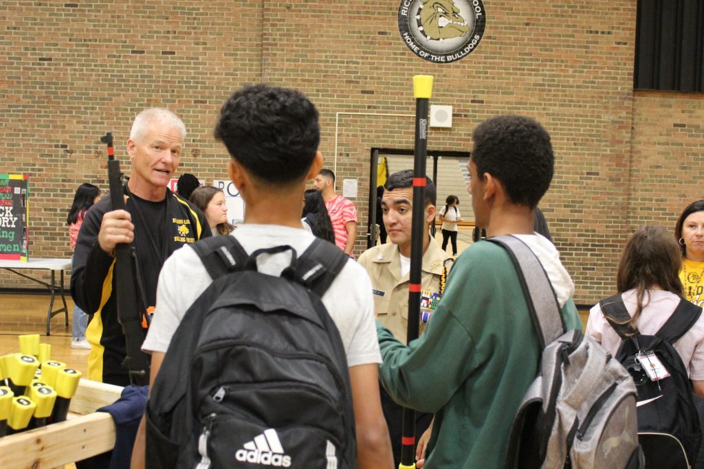 Navy Cdr. (ret.) Doug Groters talks with new students about the U.S. Navy JROTC program during Freshman Day at Richards High School. (Supplied photos)