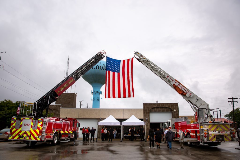 An American flag is draped in front of the McCook fire station during 9-11 ceremonies. (Photo by Carol McGowan)