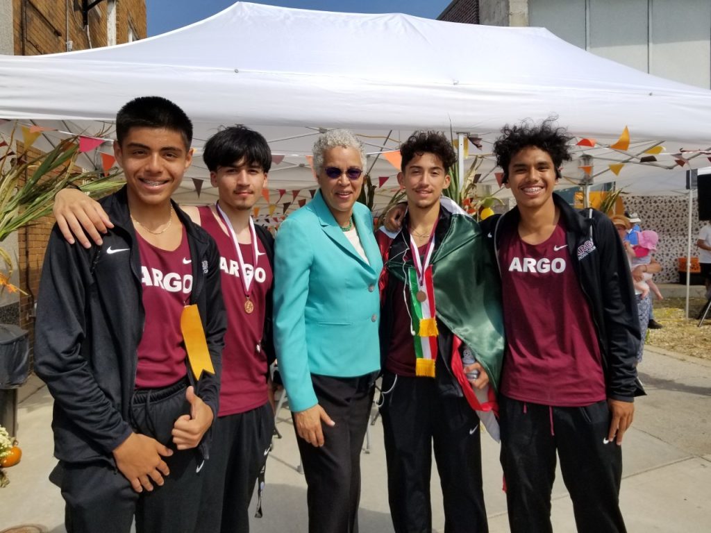 Members of Argo High School's Track Team pose for a picture with Cook County Board President Toni Preckwinkle at Fall Fest. (Photo by Carol McGowan)