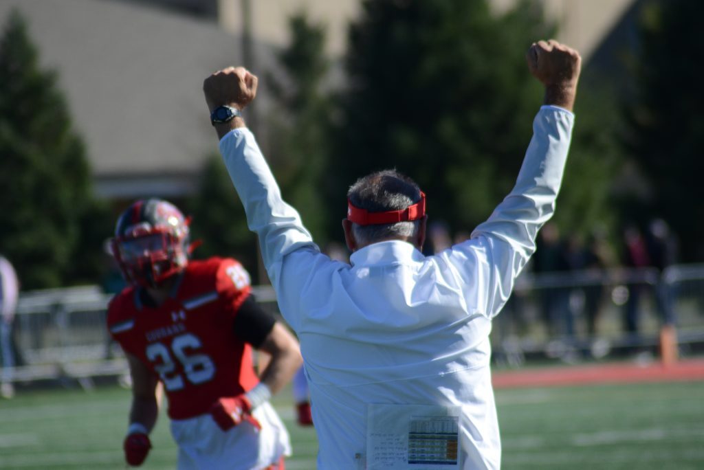 SXU coach Mike Feminis reacts as the final horn goes off as he earns his 200th career win in a thriller over 18th-ranked Roosevelt. Photo by Jeff Vorva