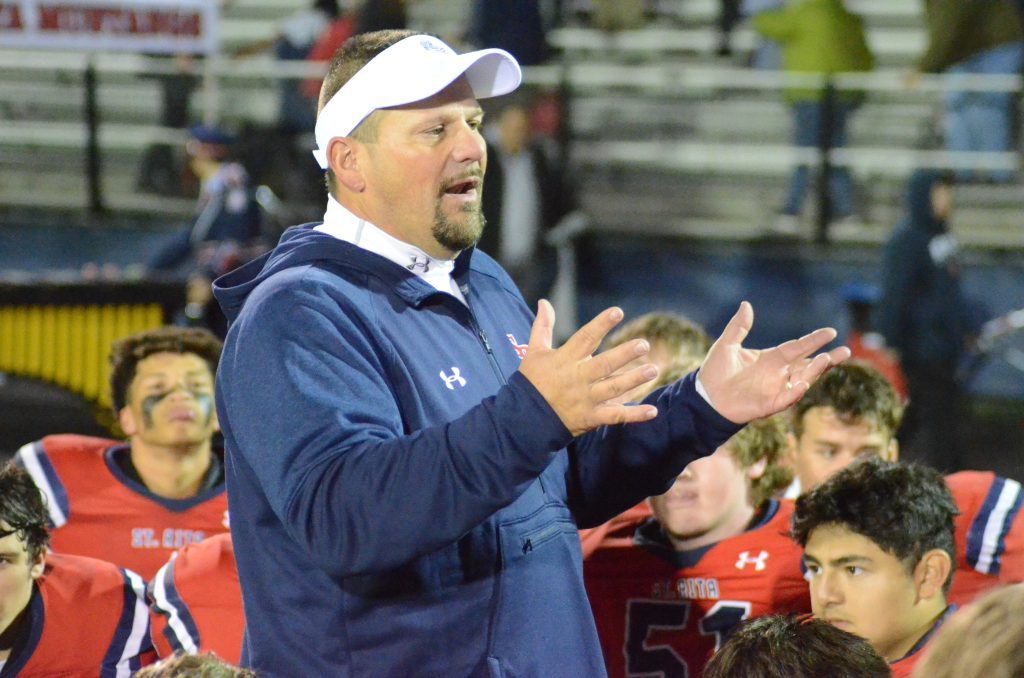 St. Rita coach Todd Kuska addresses his troops after Friday's playoff win over Geneva. Photo by Jeff Vorva