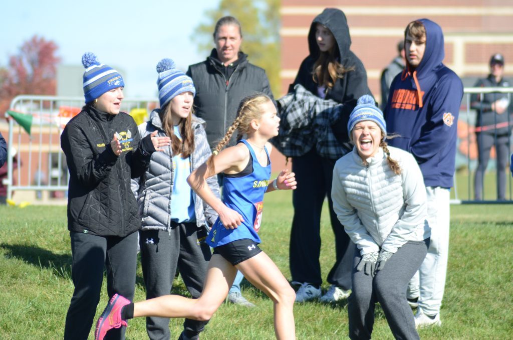 Sandburg freshman Lindsey Gerhardstein, shown receiving encouragement during the SWSC Conference meet earlier in the month, won a regional title on Saturday. Photo by Jeff Vorva