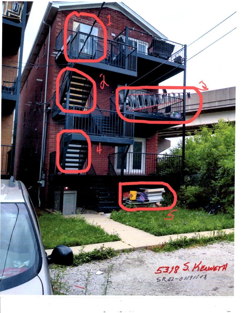 A view of the rear of the 5318 S. Kenneth residential building, with purported safety hazards circled by the Archer Heights Civic Association. The CTA Orange Line tracks are in the background. --Supplied photo