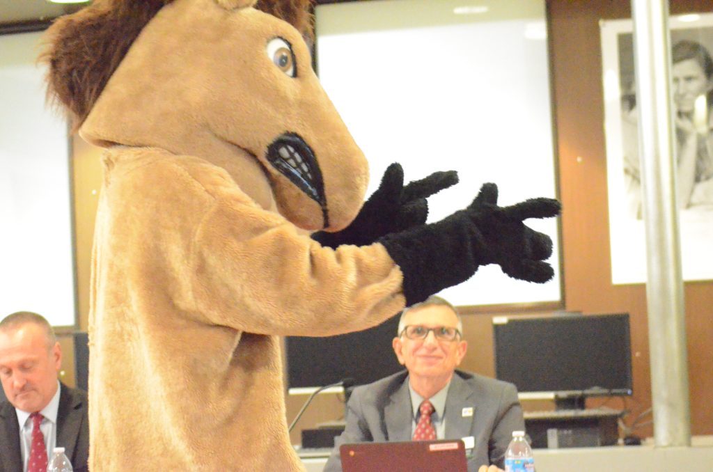 Stagg High School's mascot was at the Oct. 27 board meeting and horsed around a little during a part of it as Board President Tony Serratore looks on. (Photo by Jeff Vorva)