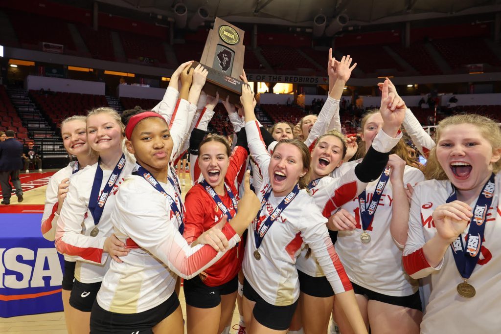 Mother McAuley players celebrate their Class 4A state title, which they won Nov. 12 with a three-set victory over Benet at Redbird Arena. Photo by Randy Whalen
