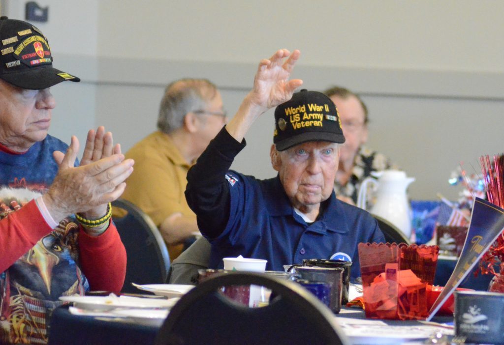 Palos Park World War II vet Rich Olund, 98, waves to the crowd at the Palos Heights Veterans Breakfast on Nov. 10. (Photo by Jeff Vorva)