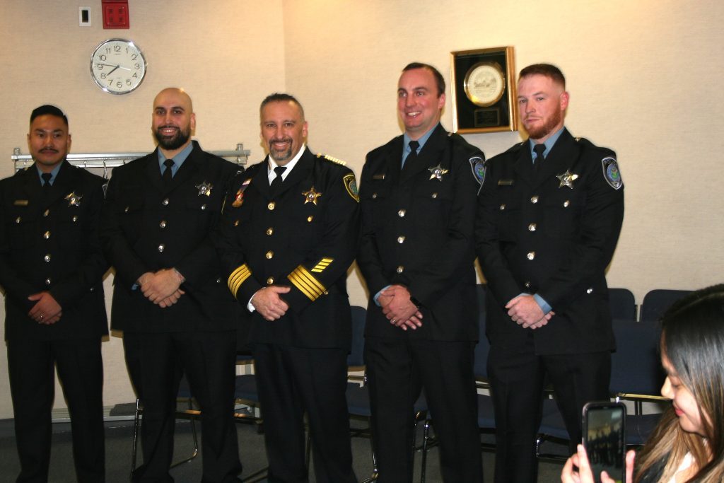 Four new police officers were sworn in on Nov. 8 by Police Chief Dan Vittorio (third from left) at the Oak Lawn Village Board meeting. The new patrol officers are (from left) Alekhine Aguilos, Iarahim Mansour, Robert Schmidt II and Daniel Cronin. (Photo by Joe Boyle)