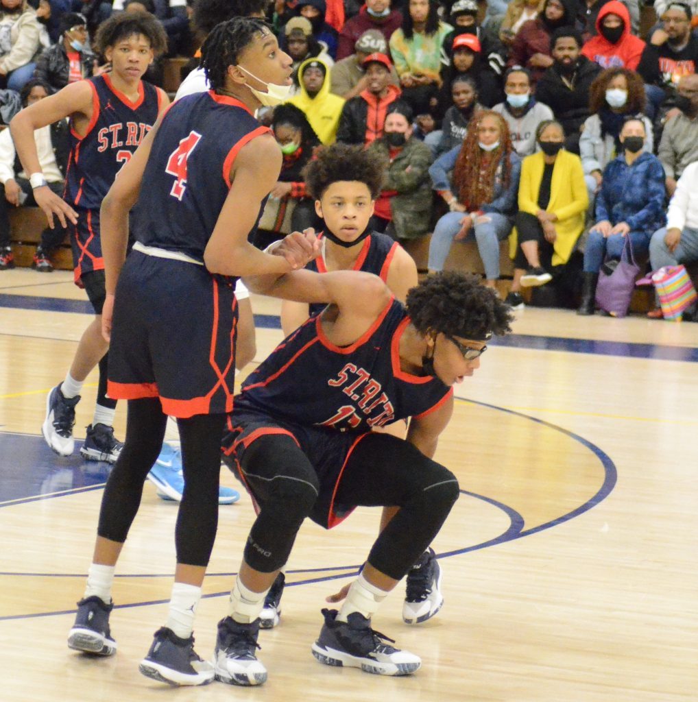 St. Rita's Melvin Bell helps up teammate James Brown during last season's sectional loss to Kenwood. The two Class 4A state powers could be on a collision course in sectional action again this year. Photo by Jeff Vorva