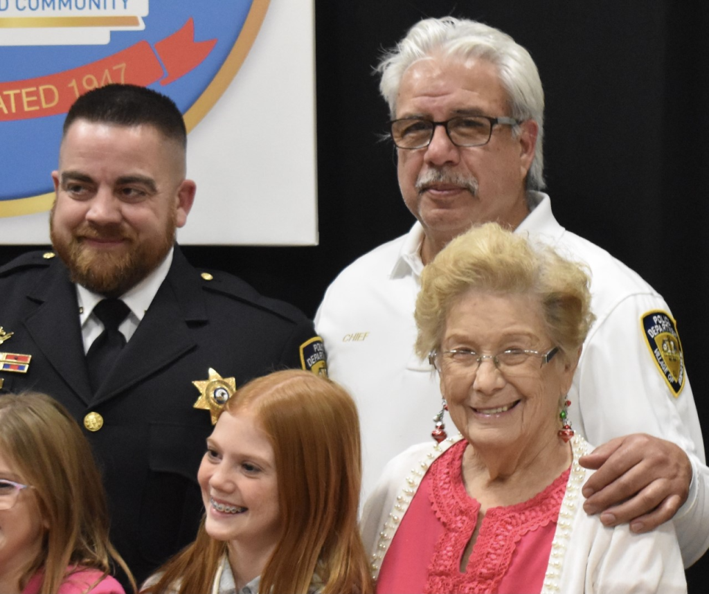 Justin Brown smiles after being sworn in as Bridgeview’s newest police sergeant. He’s with Police Chief Ricardo Mancha and Village Trustee Norma Pinion. (Photo by Steve Metsch) 