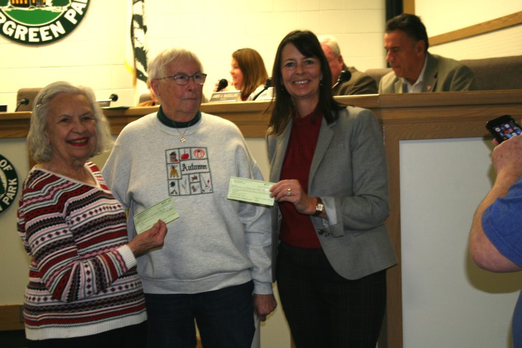 Virginia Wrobel (from left) and Dorothy Novotney, of the Evergreen Park Senior Citizens Council, present checks to Mayor Kelly Burke from proceeds from the annual "Memories to Go" village-wide garage sale. (Photos by Joe Boyle)