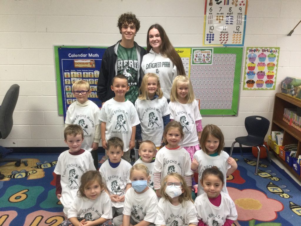 Jack Donnelly and Helen Joyce help Southwest School kindergarten children model their new Future Mustang shirts. (Supplied photos)