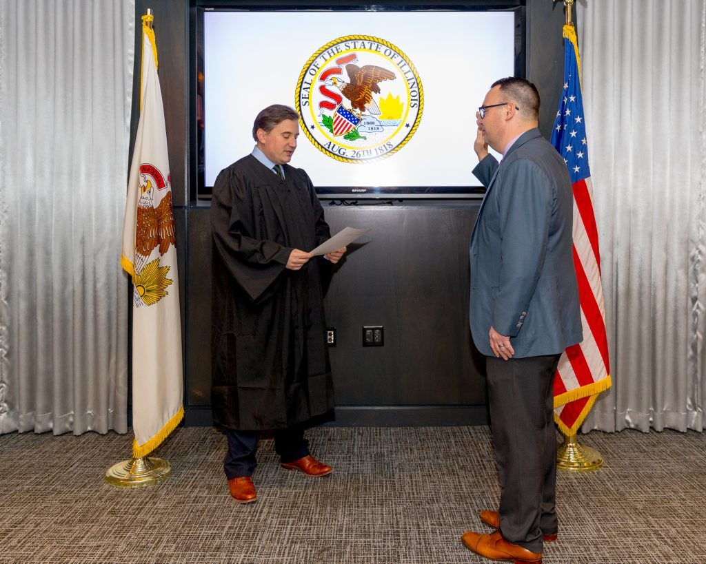Newly elected Judge Nick Kantas gives the oath of office to Senator Mike Porfirio. (Supplied photos)