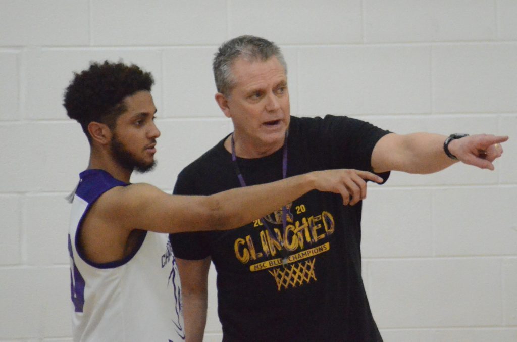 Chicago Christian boys basketball coach Kevin Pittman talks with Mason Torres at a recent Knights practice. Pittman recently won his 250th career game, all with Chicago Christian. Photo by Jeff Vorva