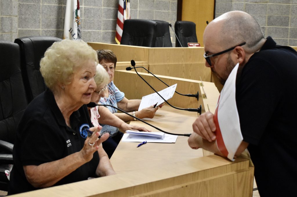 Bridgeview Trustee Mary Sutton, who died Wednesday, chats with Community Service Representative Ken Pannaralla Jr., at a June 2022 board meeting. (Photo by Steve Metsch)