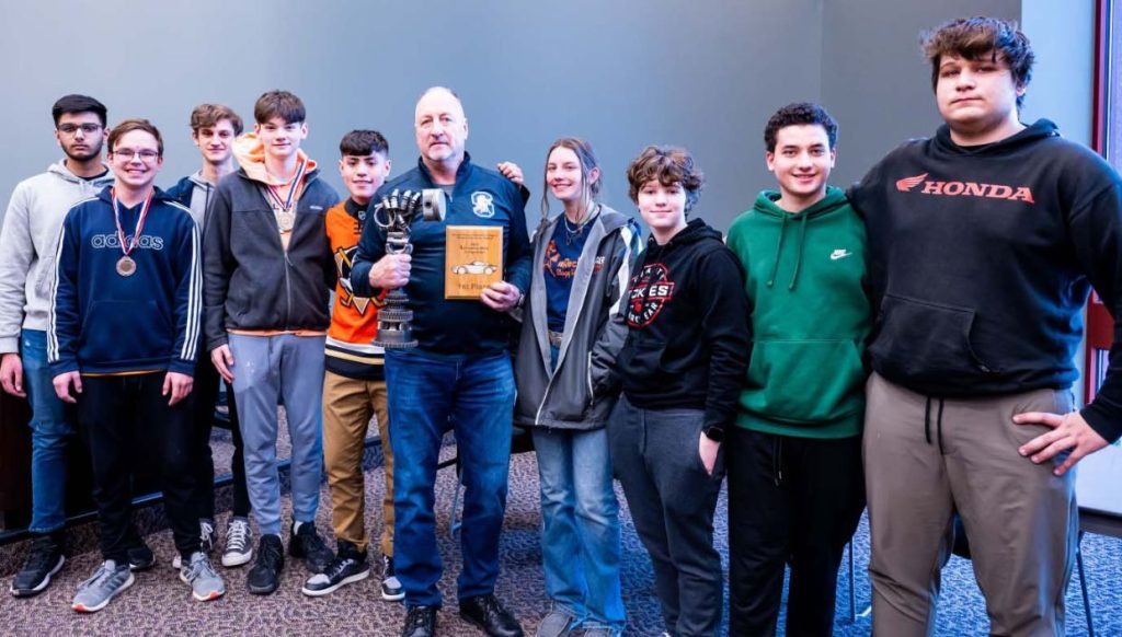 Stagg High School automotive team with auto teacher Bernard Kay (middle) with the traveling first place High School Automotive Technology Skills Competition team trophy. (Supplied photos) 
