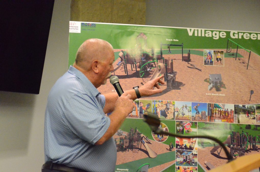 NuToys Sales Rep Rick Bieterman gives details on a playground improvements at Village Green Park on April 10. (Photo by Jeff Vorva)