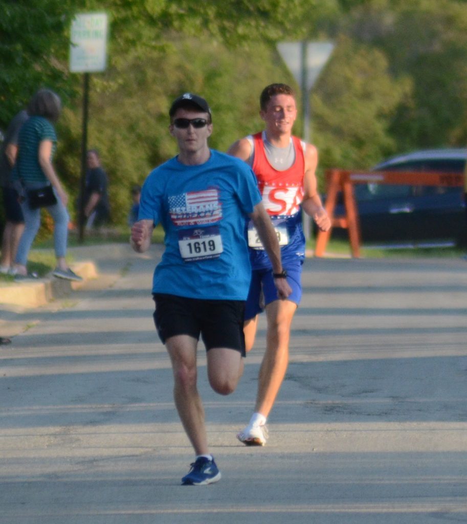 Patrick Gannon of Orland Park passes Owen Ford of Minnesota to win the Veterans Liberty Run, held July 3 in Orland Park. Photo by Jeff Vorva