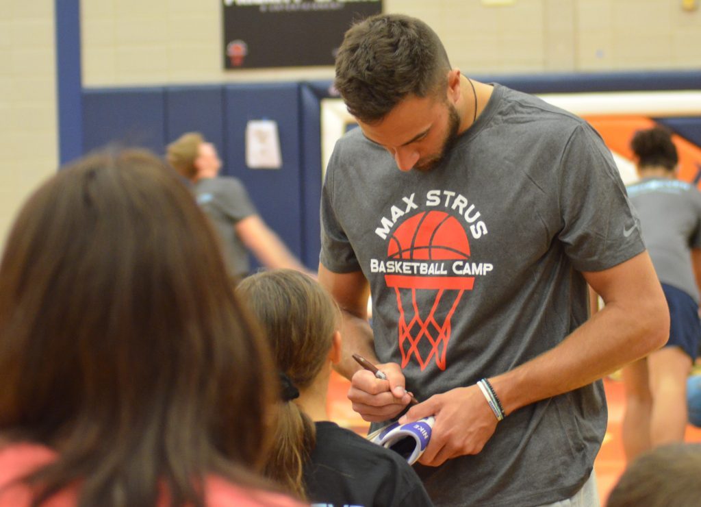 NBA standout Max Strus signs a shoe for one of the players at his camp at Stagg High School. Photo by Jeff Vorva