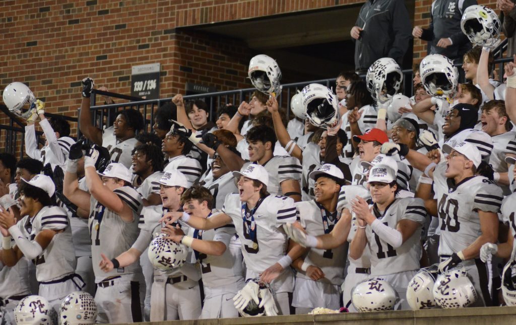 Mount Carmel players, here celebrating their Class 8A championship in Champaign last season, will open the season in Normal with a game against East. St. Louis Senior. Photo by Jeff Vorva