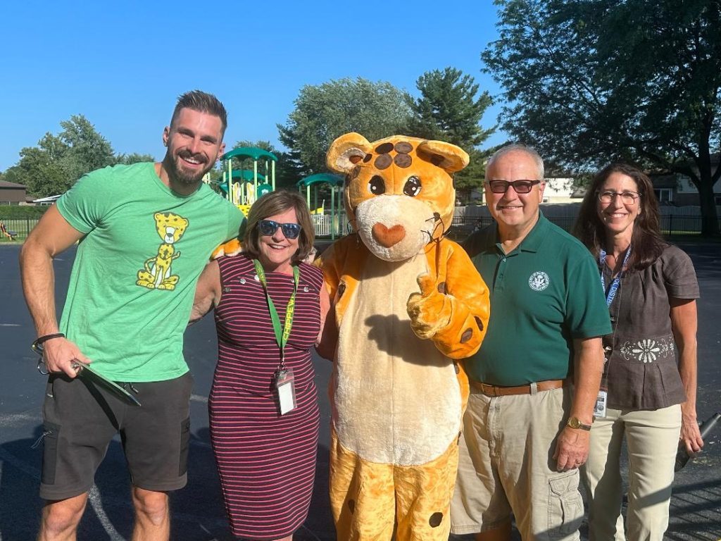 Sean Bartelt, District 128 physical education instructor (from left); Principal Mary Lynn Duffy; the Chippewa mascot; Palos Heights Mayor Bob Straz; and District Supt. Dr. Merryl Brownlow, at Chippewa School's playground ribbon-cutting on August 16. (Photos by Kelly White)