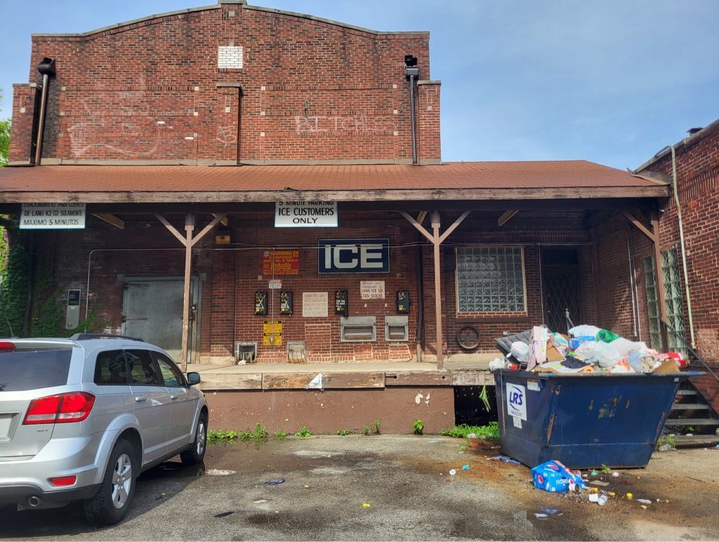 The loading dock of the old icehouse includes an overflowing Dumpster and other clutter. --Supplied photo